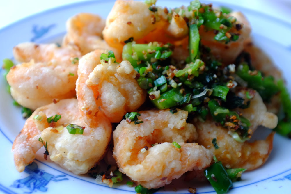 An image of Salt and Peppered Shrimp on a blue dish.